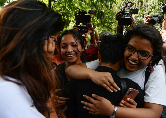 Members of the lesbian, gay, bisexual, transgender (LGBT) community celebrate outside the Supreme Court In India