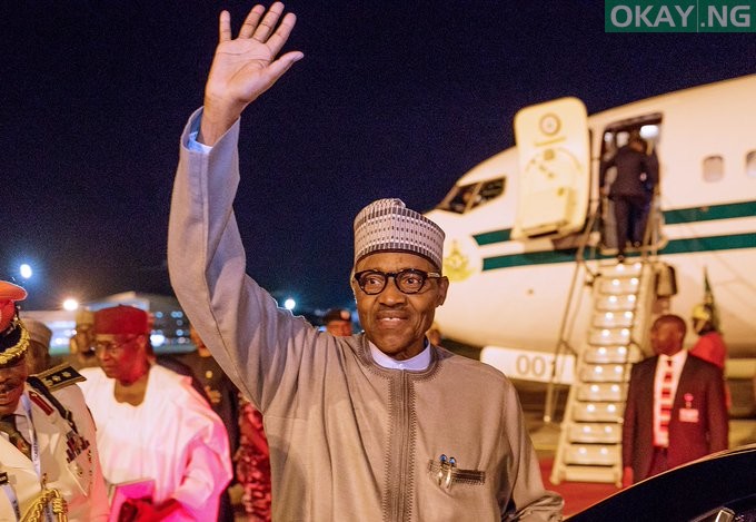 President Muhammadu Buhari waving his hand on arrival in Abuja from Japan