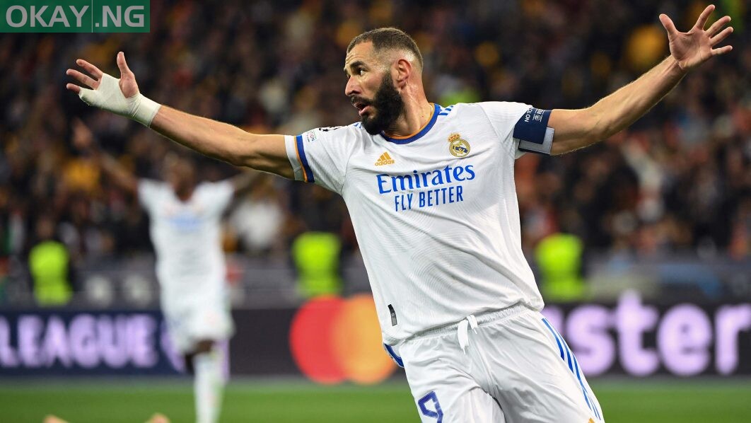 Real Madrid’s French forward Karim Benzema celebrates after Shakhtar Donetsk’s Ukrainian defender Serhiy Kryvtsov scored an own goal during the UEFA Champions League football match between Shakhtar Donetsk and Real Madrid at the Olympic Stadium in Kiev on October 19, 2021. (Photo by Sergei SUPINSKY / AFP)