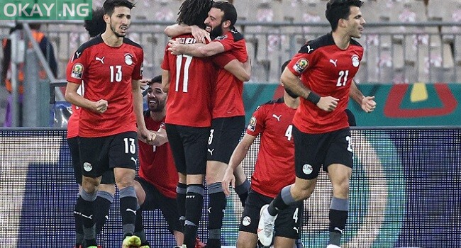 Egypt’s players celebrate their second goal during the Africa Cup of Nations (CAN) 2021 quarter-final football match between Egypt and Morocco at Stade Ahmadou Ahidjo in Yaounde on January 30, 2022. (Photo by Kenzo Tribouillard / AFP)