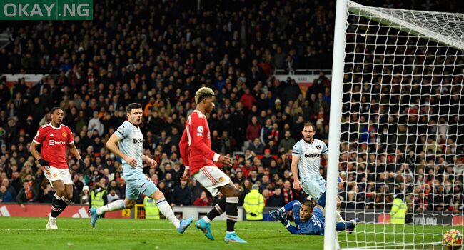 Manchester United’s English striker Marcus Rashford (C) scores the opening goal past a diving West Ham United’s French goalkeeper Alphonse Areola (R) during the English Premier League football match between Manchester United and West Ham United at Old Trafford in Manchester, north west England, on January 22, 2022. Oli SCARFF / AFP