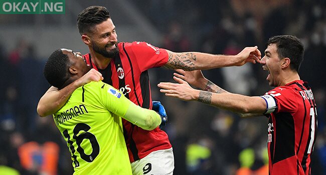 AC Milan’s French goalkeeper Mike Maignan (L), AC Milan’s French forward Olivier Giroud (C) and AC Milan’s Italian defender Alessio Romagnoli (R) celebrate their victory at the end of the Italian Serie A football match between Inter Milan and AC Milan at the Giuseppe-Meazza (San Siro) stadium in Milan on February 5, 2022. Isabella BONOTTO / AFP