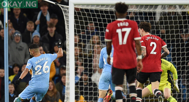 Manchester City’s Algerian midfielder Riyad Mahrez (L) shoots to score their fourth goal during the English Premier League football match between Manchester City and Manchester United at the Etihad Stadium in Manchester, north west England, on March 6, 2022. Manchester City won the game 4-1. Oli SCARFF / AFP
