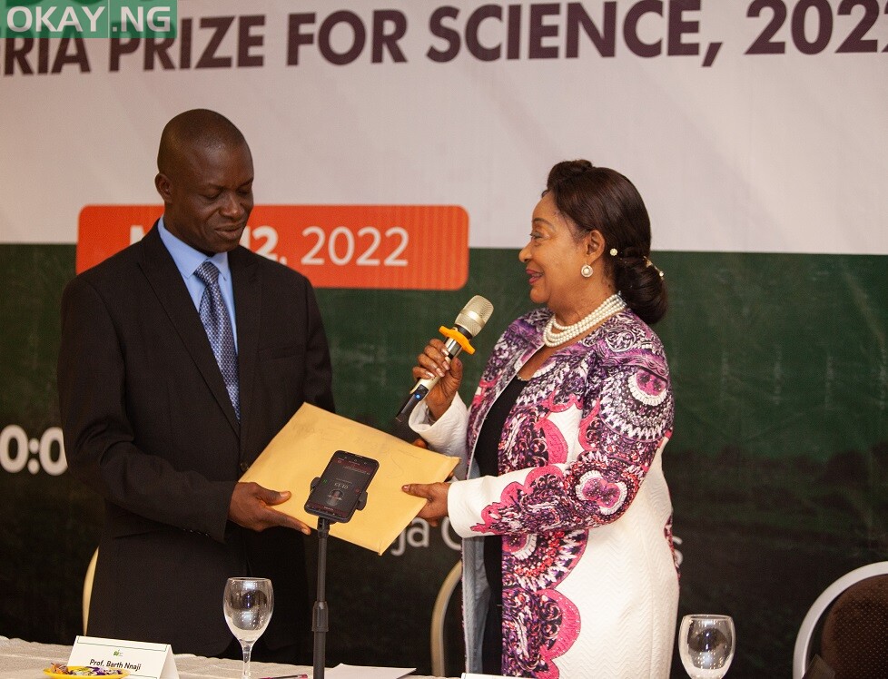 Member of the Advisory Board for NLNG-sponsored The Nigeria Prize for Science, Chief Dr. Nike Akande, hands over the 2022 entries to the Chairman, panel of judges for this year's competition, Professor Christian Ugwu Agbo, at a ceremony in Lagos today.