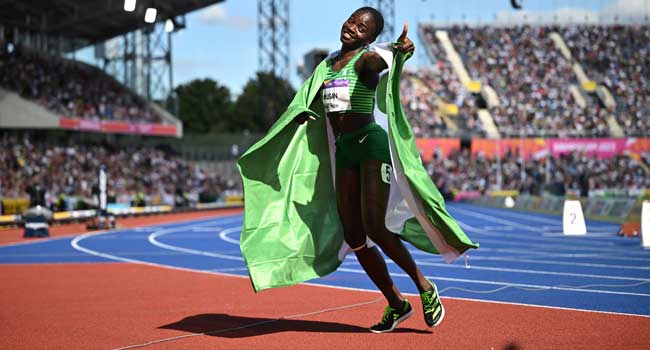 Nigeria’s Tobi Amusan celebrates winning and taking the gold medal in the women’s 100m hurdles final athletics event at the Alexander Stadium, in Birmingham on day ten of the Commonwealth Games in Birmingham, central England, on August 7, 2022. (Photo by Ben Stansall / AFP)