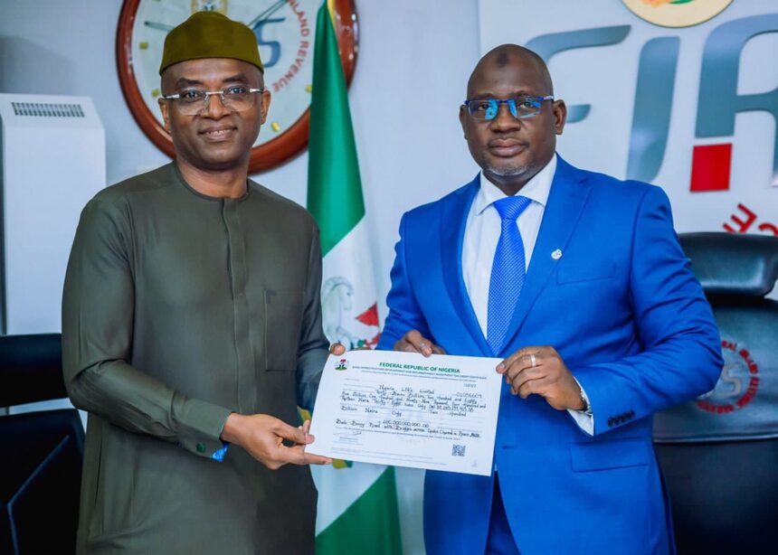 Executive Chairman, FIRS, Muhammad Nami with Deputy Managing Director, NLNG, Mr. Olalekan Ogunleye showing Tax Credit Certificate handed to NLNG for the construction of the Bonny - Bodo Road and Bridge, Rivers State. 18th August 2022.