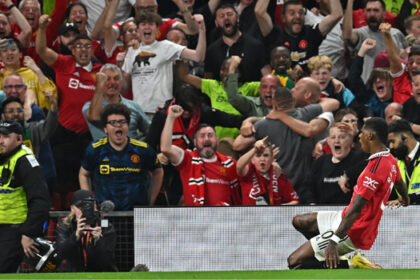 Manchester United’s English striker Marcus Rashford (R) celebrates in front of supporters after scoring their second goal during the English Premier League football match between Manchester United and Liverpool at Old Trafford in Manchester, north west England, on August 22, 2022. (Photo by Paul ELLIS / AFP)