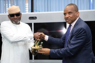 The Honourable Minister of Transportation, Engr. Mu'azu Jaji Sambo (left) receiving a souvenir from the Director General, Nigerian Maritime Administration and Safety Agency, NIMASA, Dr Bashir Jamoh during a visit by the Honourable Minister to the NIMASA headquarters in Lagos.